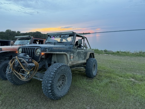 Scrap Metal Jr staged at sunset by the water